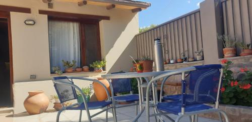 a table and two chairs on a balcony with a table at La Casa de los Molles in Tilcara