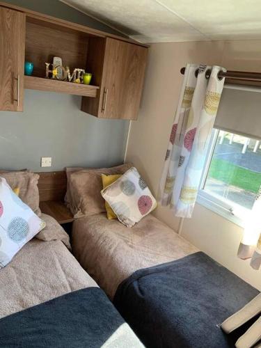 a small room with a couch and a window at Crimdon dene bay view holiday home NO SMOKING NO PETS in Durham