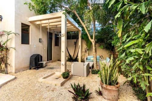 a backyard with a patio with a heater and some plants at Casa Esperanza Tulum Private Pool in Tulum