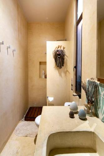 a bathroom with a sink and a toilet in it at Casa Esperanza Tulum Private Pool in Tulum