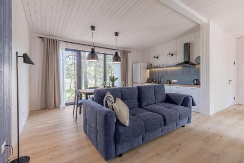 a living room with a blue couch and a table at Заміський комплекс - DOGODA in Dzvinkove