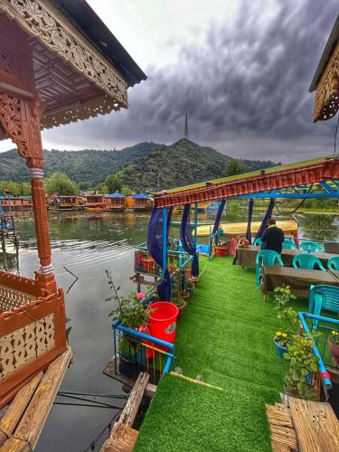 a boat on the water with grass on the side at Heritage Shreen Houseboat in Srinagar