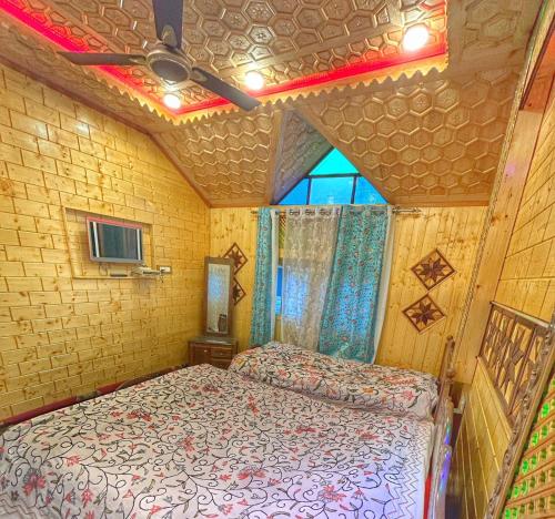 a bedroom with a bed in a small room at Heritage Shreen Houseboat in Srinagar