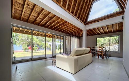 a living room with a white couch and a table at Villa Magnolia in Rabo de Peixe