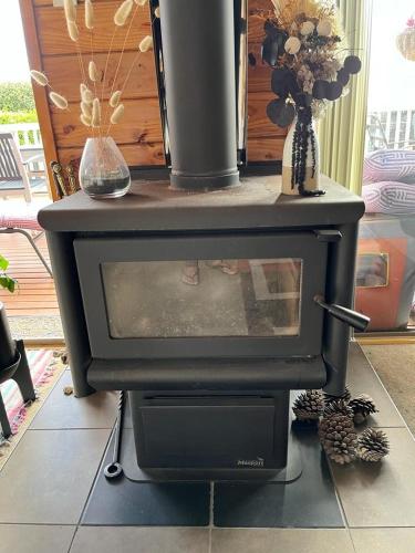 a black stove sitting on top of a room at Red Beach Retreat in Red Beach