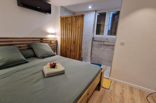 a bedroom with a bed with a flower on it at Appartement les petits Baobabs 2 in Mamoudzou