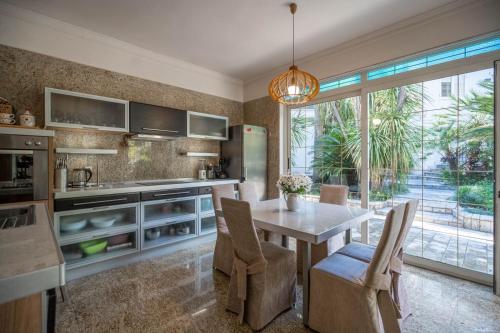 a kitchen with a table and chairs and a large window at Villa Nautica in Herceg-Novi