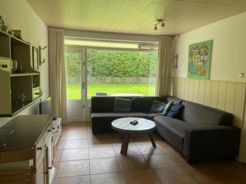 a living room with a couch and a table at Vakantiehuisje Martina 17 in Vlissingen