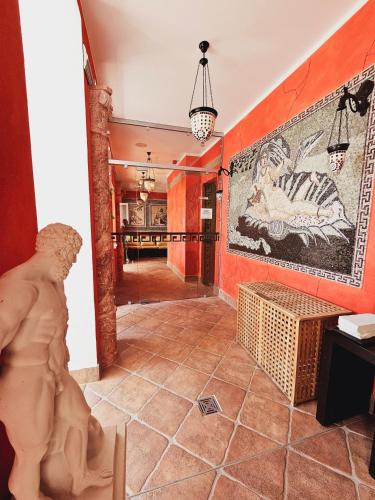 a hallway with a large painting on the wall at Alexa Hotel in Göhren