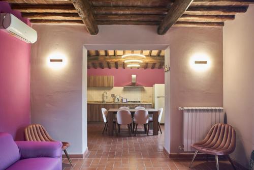 a kitchen and dining room with a table and chairs at Podere Sant'Antonio in Asciano