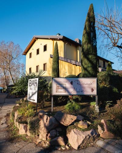 a sign in front of a house with a building at Hotel Ristorante Vecchia Riva in Varese