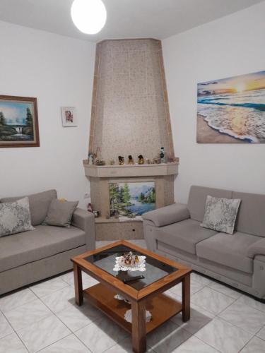 a living room with a couch and a coffee table at Luxury Dennis Home in Sarandë