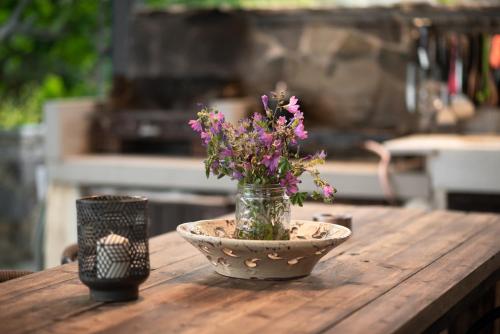 a vase with flowers in it sitting on a table at Villa Appetite in Marmarion