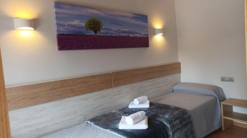 a room with a bed and a tree on the wall at Hostal A Cantina de Renche in Renche