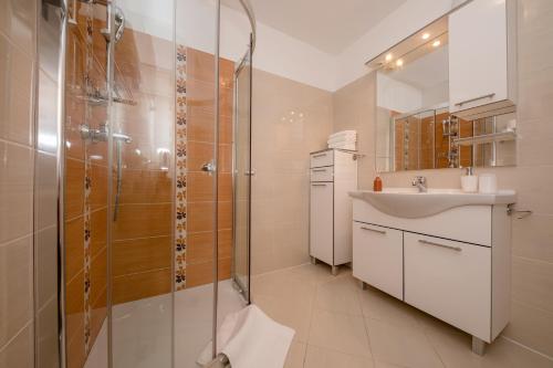 a bathroom with a shower and a sink at Apartments Kos in Supetarska Draga