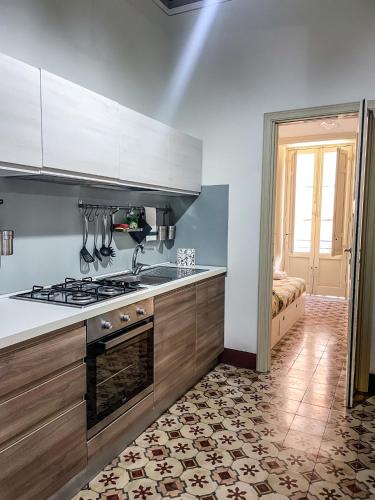a kitchen with a stove top oven in a room at L'isola Felice in Trapani