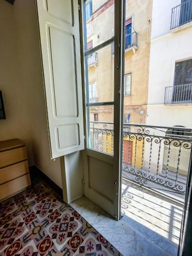 a door to a balcony with a view of a building at L'isola Felice in Trapani