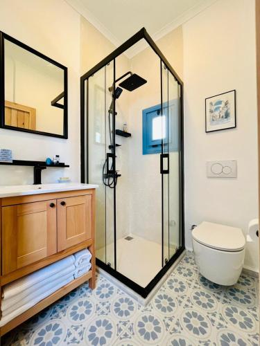 a bathroom with a shower and a toilet and a sink at Jakaranda Unique Apart in Bodrum City