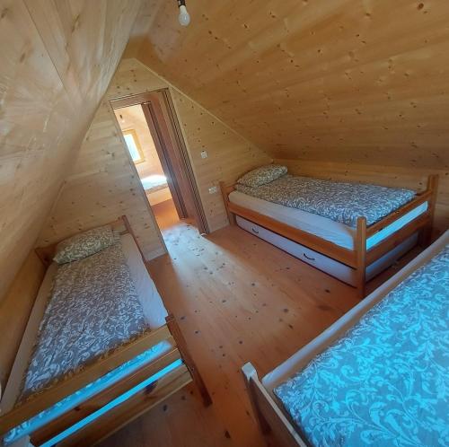 an overhead view of two beds in a wooden cabin at Brunarica Jeršin in Cerkno