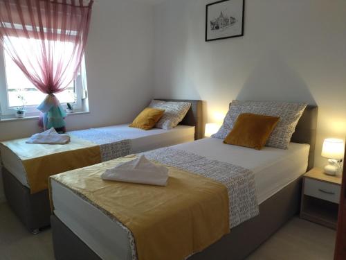 Postel nebo postele na pokoji v ubytování Apartments Mihoci