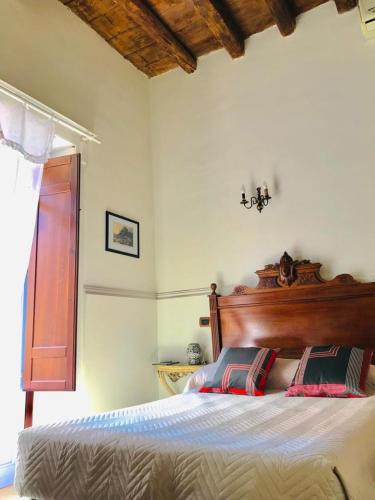 a bedroom with a bed with two pillows on it at Antica Dimora San Girolamo in Licata
