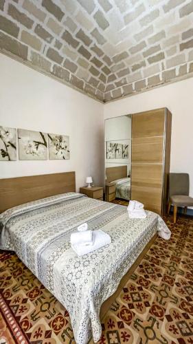 a bedroom with a bed with two towels on it at L'isola Felice in Trapani