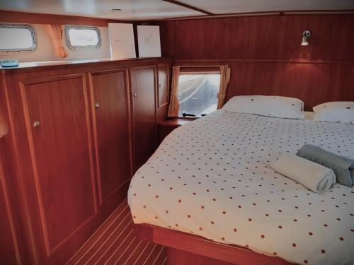 a bedroom with a bed in the middle of a boat at Motor Yacht Amazone in Amsterdam