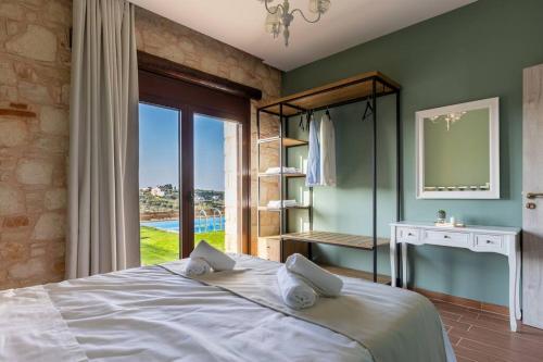 a bedroom with a large bed and a window at Villa Õtium in Epáno Váthia
