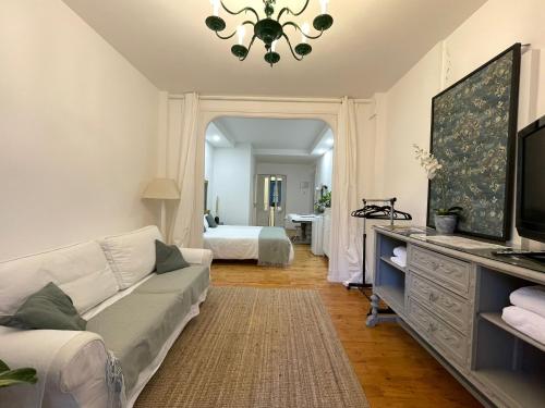 een woonkamer met een bank en een bed bij Habitación Centro Pamplona - acceso independiente in Pamplona