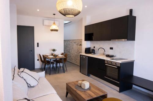 a living room with a couch and a kitchen at VENUS LUXURY APARTMENT in Ermoupoli