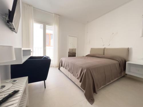 una camera bianca con letto e scrivania di Maruzza Home a Favignana