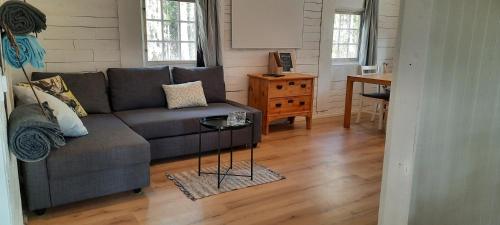 a living room with a couch and a table at Davids Stuga in Klässbol