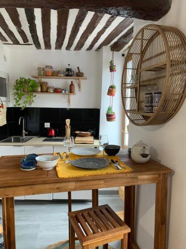 a kitchen with a wooden table with bowls on it at Studio Wanderlust in Le Bar-sur-Loup