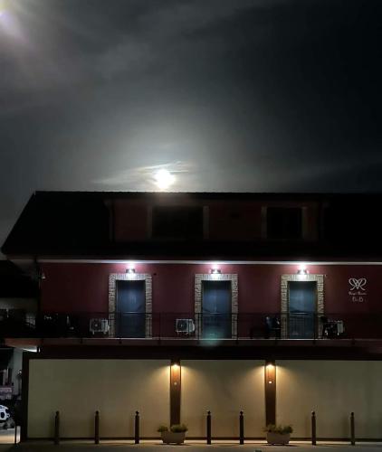 a building with a light on top of it at night at Rosy's Rooms in Patrica