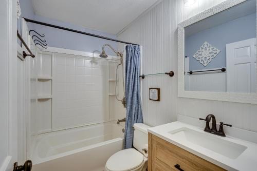 a bathroom with a sink and a tub and a toilet at Lakefront Vacation Rental with Views and Hot Tub! in Bracey