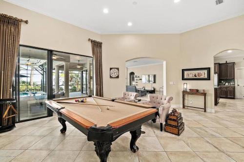 a large room with a pool table in it at Florida Space Coast Waterfront Retreat in Cocoa