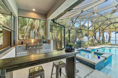 a house with a pool and a kitchen and a swimming pool at Florida Space Coast Waterfront Retreat in Cocoa