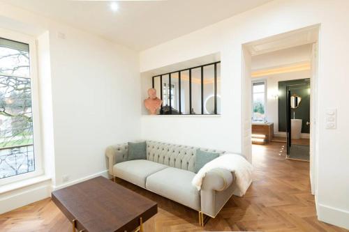 a living room with a couch and a table at L'appartement du château in Morvillars