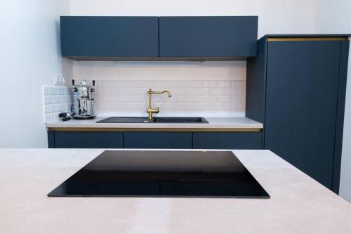 a kitchen with a sink and a counter top at L'appartement du château in Morvillars