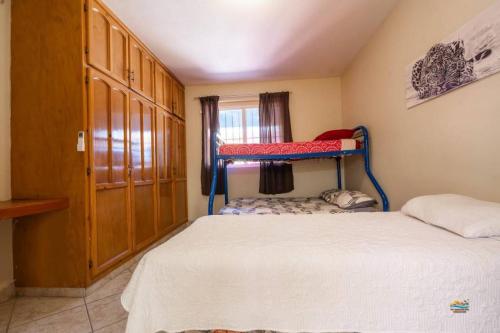 a bedroom with two bunk beds and a window at Condo 4 In town and steps to the beach and Malecon in San Felipe