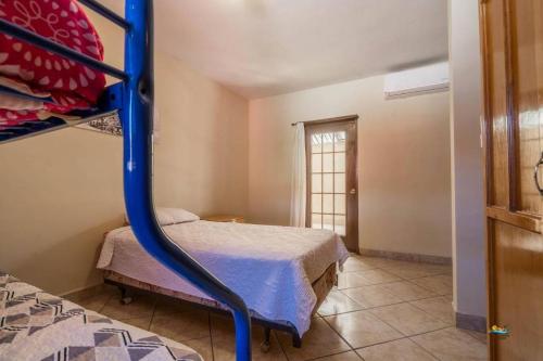 a bedroom with a bunk bed and a bed at Condo 4 In town and steps to the beach and Malecon in San Felipe