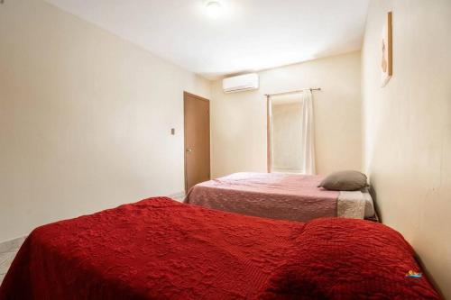 a room with two beds and a red blanket at Condo 4 In town and steps to the beach and Malecon in San Felipe