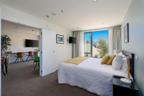 a hotel room with a bed and a large window at Palazzo Motor Lodge in Nelson