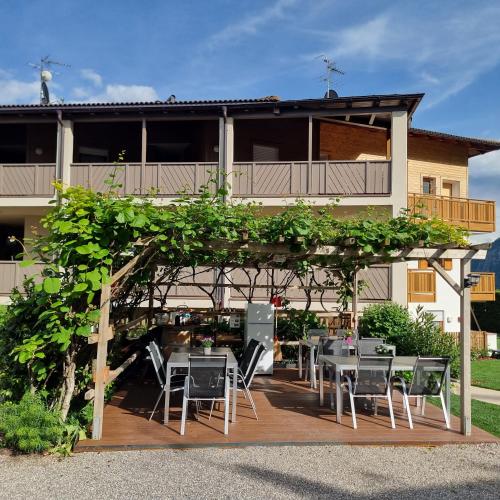 a patio with tables and chairs in front of a building at Haus Hofer *** in Andrian