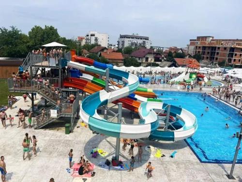 a water slide in a swimming pool with people at Apartment luxury Ub in Ub
