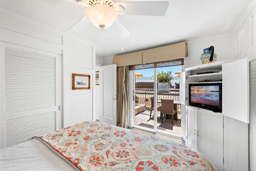 a bedroom with a bed and a flat screen tv at Villa Calypso in Laguna Beach