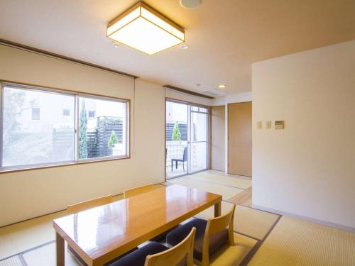 an empty room with a wooden table and chairs at Spa and Resort Hotel Solage Oita Hiji Beppuwan in Beppu