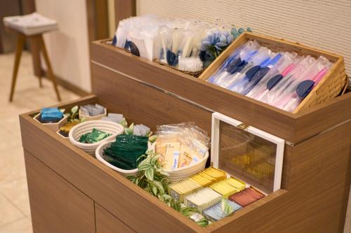 a wooden box filled with lots of items at Hotel Resol Machida in Machida