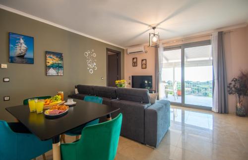 a living room with a table and a couch at The View Villa in Maryiés