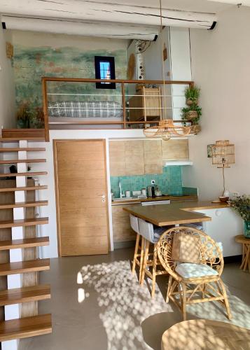 a room with a table and chairs and a loft at Front de mer 35m2 vue époustouflante in Carry-le-Rouet